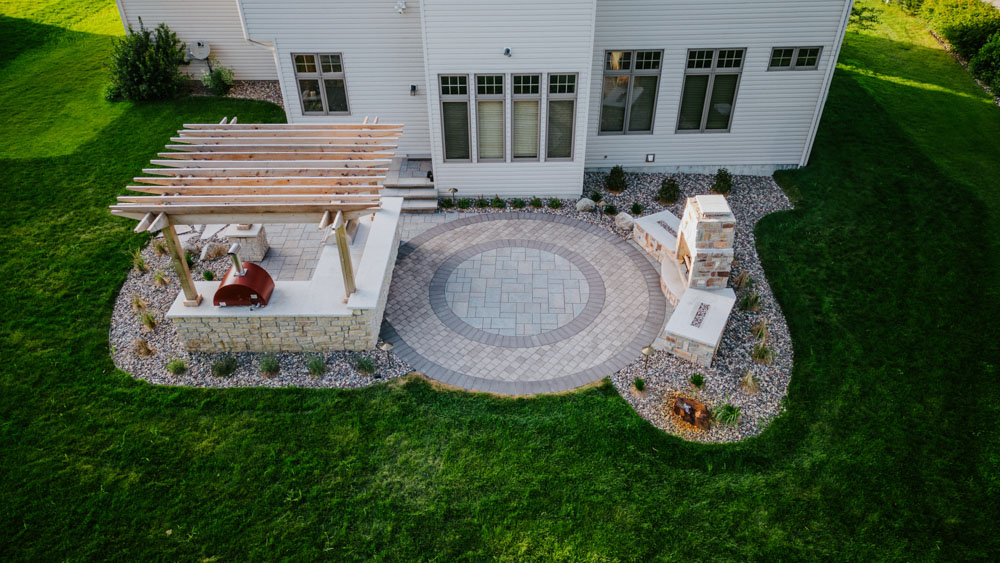 aerial view of a backyard patio, kitchen, and fireplace in rochester, mn