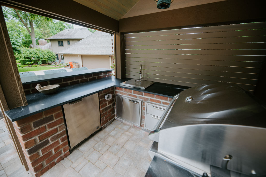 the interior of an outdoor kitchen with custom masonry