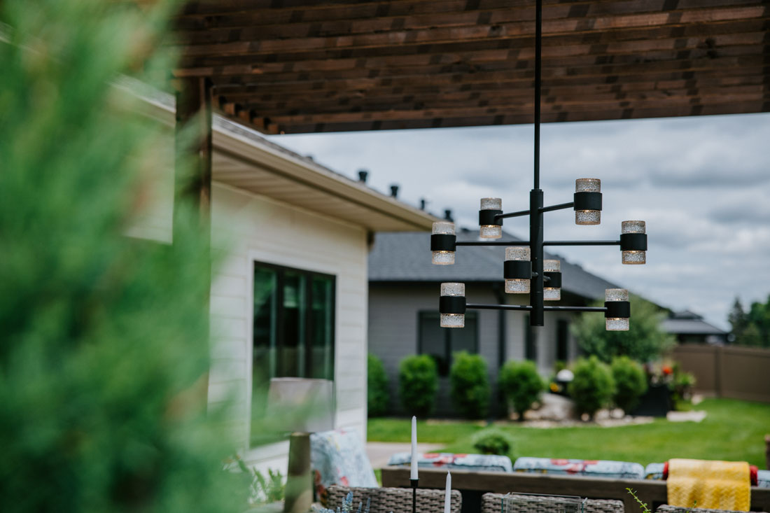 outdoor chandelier over dining area