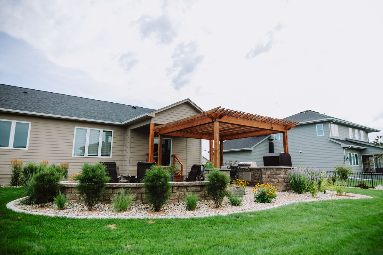backyard landscaping with a patio and pergola in south dakota