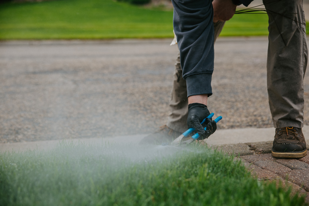 Irrigation specialist performing an irrigation service in Sioux Falls, SD.