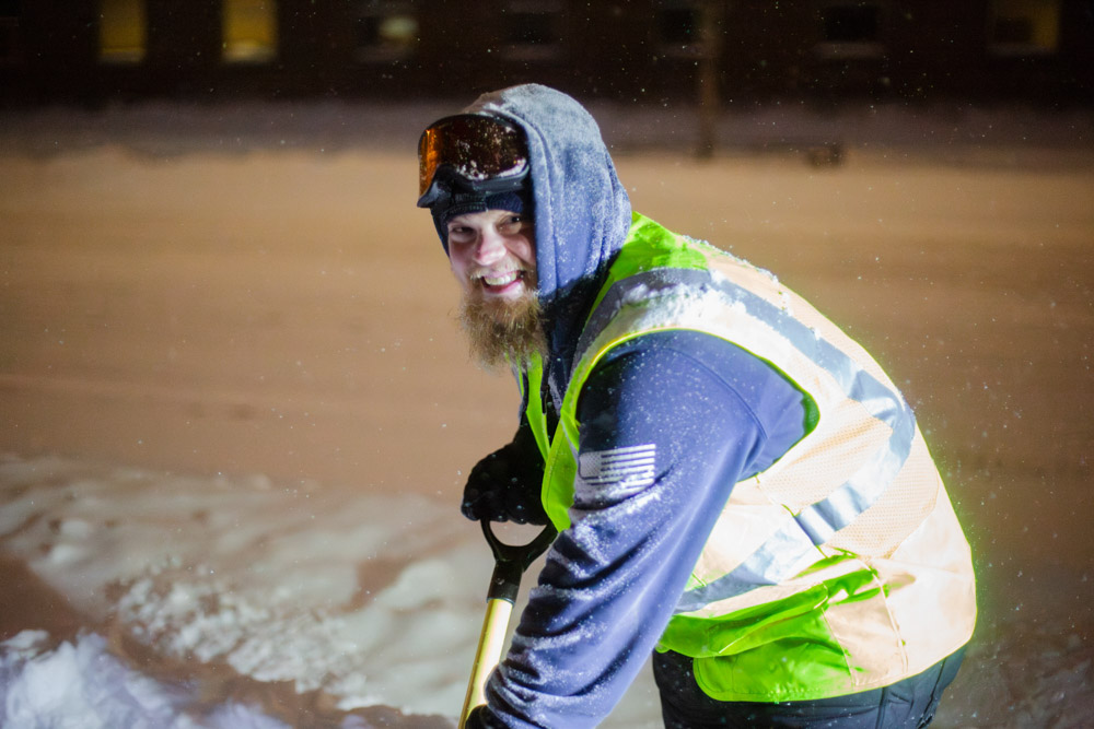 Weller Brothers team member shovels snow