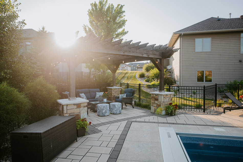 Cedar wood pergola with natural stone columns designed by Weller Brothers Landscaping.