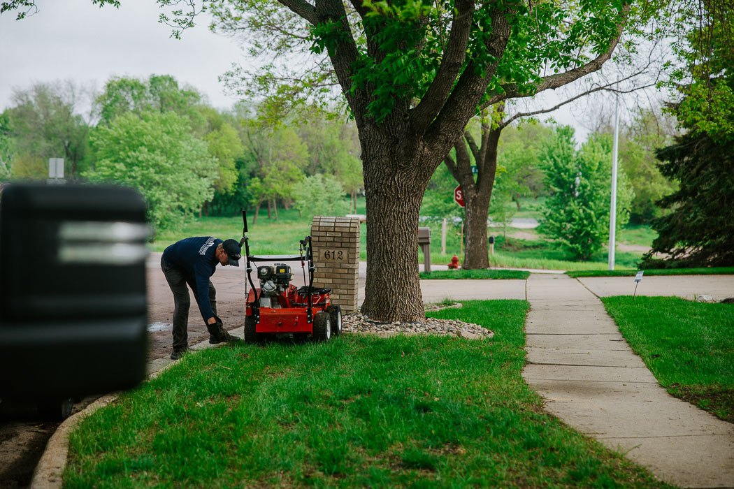 Weller Brothers lawn care professional overseeding a Sioux Falls, SD lawn.