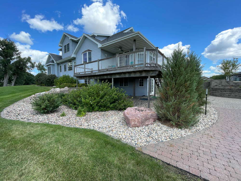 a Sioux Falls home with refreshed rock beds, edging, and plants