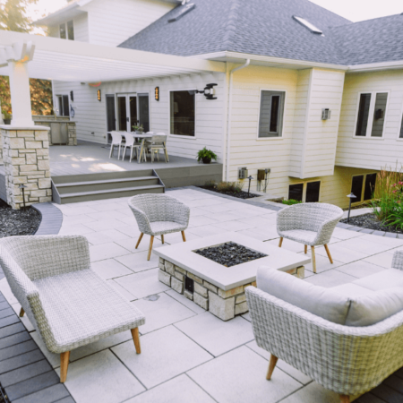 white tile patio with neutral furniture and fire pit