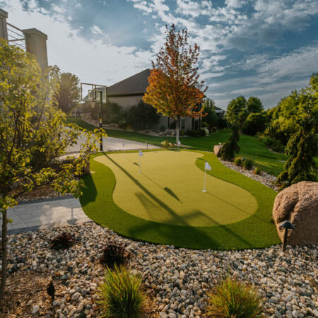 wide shot of an artificial turf putting green at sunset